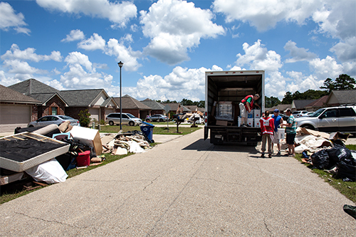 August 19, 2016. Denham Spring, Louisiana. Red Cross volunteers distribute clean-up kits and water to people starting to recover from the historic flooding in southern Louisiana. Photo by: Marko Kokic/American Red Cross
