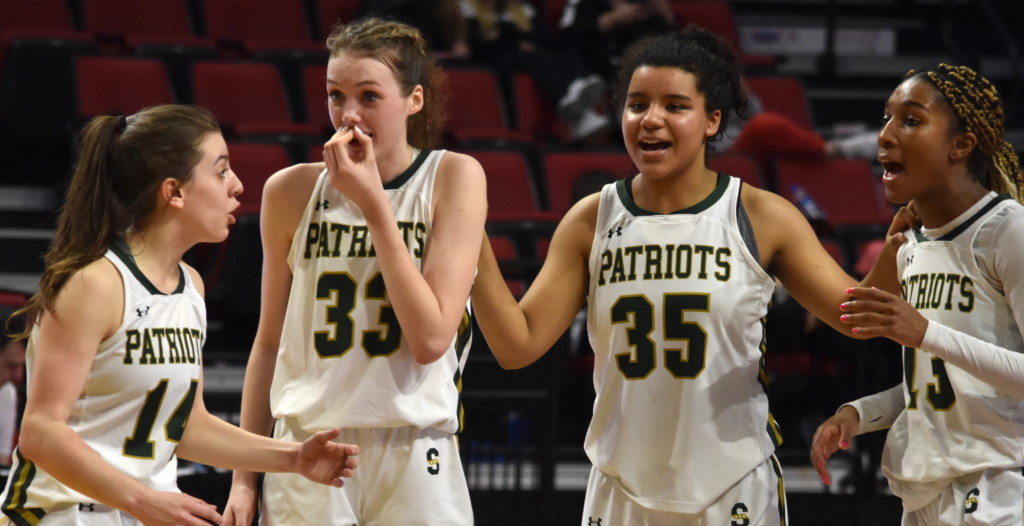 Stevenson High School players share a moment late in the Class 4A IHSA state girls basketball championship game, a win over Barrington on March 2 at Redbird Arena in Normal | Photo by Kaleb Carter