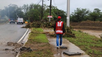 Salinas, Puerto Rico — Red Cross employee, Rosemarie Valdez, observes the damages caused on roads | Photo courtesy of Red Cross, September 19, 2022.