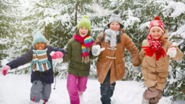 children in coats, in snow, Photo courtesy of Cradles to Crayons