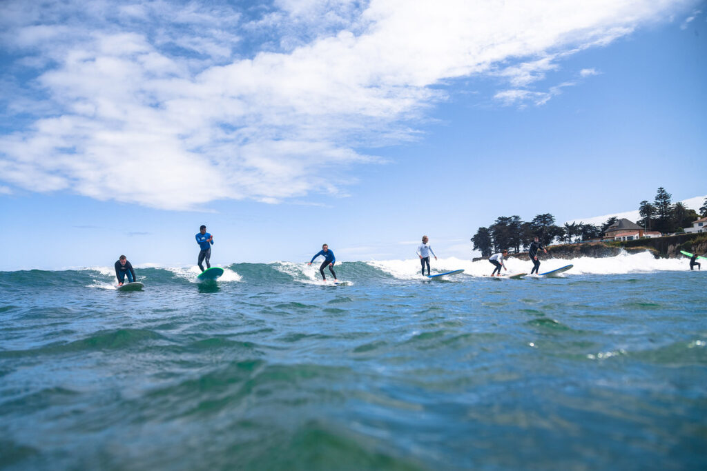 Group photo of surfers surfing, Ryan Craig
