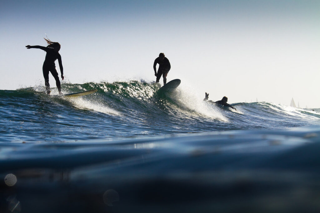 surfing in the ocean, part wave at pleasure point, ryan craig