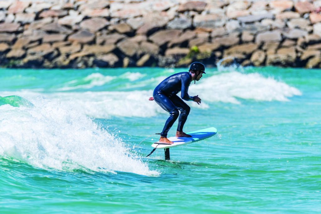 Surfer riding waves water sports trends 2021