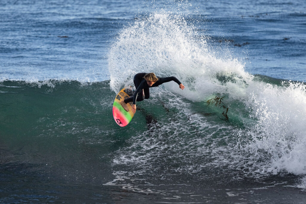 Adam Barlett surfer riding wave, photo by ryan chachi craig