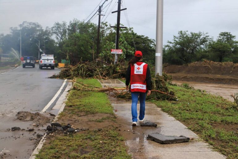 Salinas, Puerto Rico — Red Cross employee, Rosemarie Valdez, observes the damages caused on roads | Photo courtesy of Red Cross, September 19, 2022.