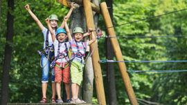 Kids having fun in ropes course adventure park