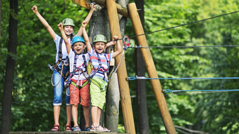 Kids having fun in ropes course adventure park