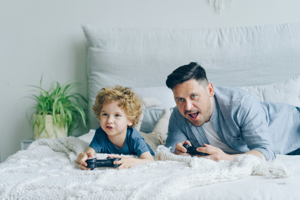 Dad playing video games with son