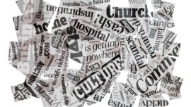 An abstract collage of newspaper headlines