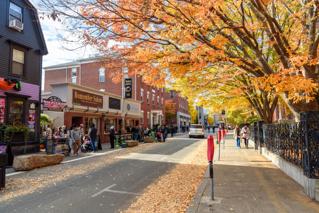 Tourist strolling along Essex street in downtown Salem in late October