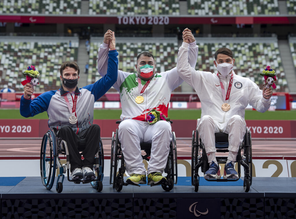 Team USA’s bronze medalist Justin Phongsavanh (right) with Iranian gold medalist Hamed Amiri and Russian silver medalist Alexey Kuznetsov on the podium at the Tokyo 2020 Paralympics