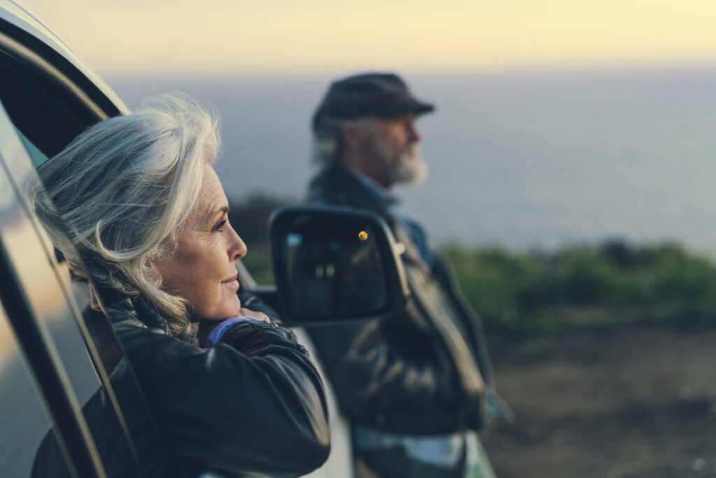 woman sitting in car during sunset