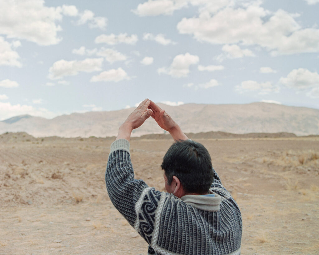 A man gestures with his hands.
