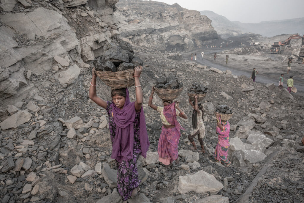 October 28, 2017: Local villagers are collecting coal from the mines in Jharia. In Jharia, Jharkhand, local villagers risk their lives in abandoned and active coal mines, collecting coal to sell for meagre earnings. Many are pushed into these dangerous activities by contractors and coal mafias, working without safety gear or proper wages. For countless families living below the poverty line—nearly 39% of residents earn less than $2 a day illegal coal collection has become a survival strategy. The environmental impact of these mining operations is severe. Open-cast and underground fires release massive amounts of greenhouse gases, including CO₂, methane, and nitrogen oxides, accelerating climate change. Dust and pollutants contaminate the air and water, while biodiversity in the region suffers. Shockingly, around 400,000 children aged 5–14 work in these mines, exposed to hazardous conditions that cause malnutrition, skin infections, and respiratory illnesses. Despite supplying a major portion of India’s coal fuelling 80% of domestic energy needs Jharia’s mines reflect a troubling trade-off: energy production comes at the cost of human health, safety, and ecological balance.