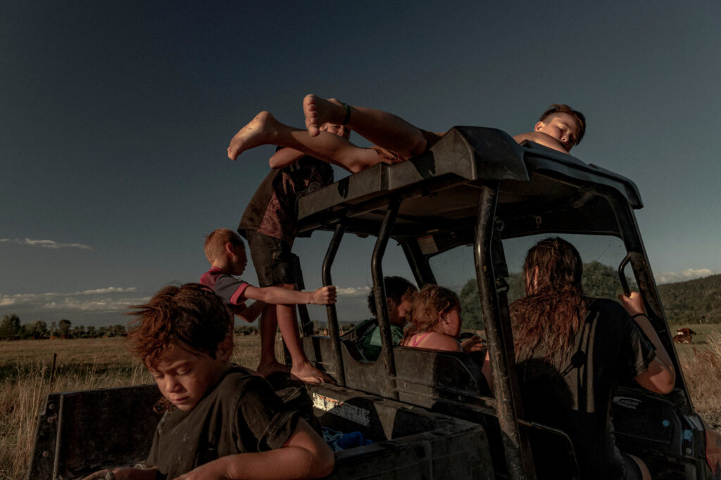 Children from the Teepa family drive the younger siblings home, after a swim in the Ōhinemataroa (Whakatane) River, in Ruatoki, New Zealand. Tūhoe children are taught independence and to care for other family members.