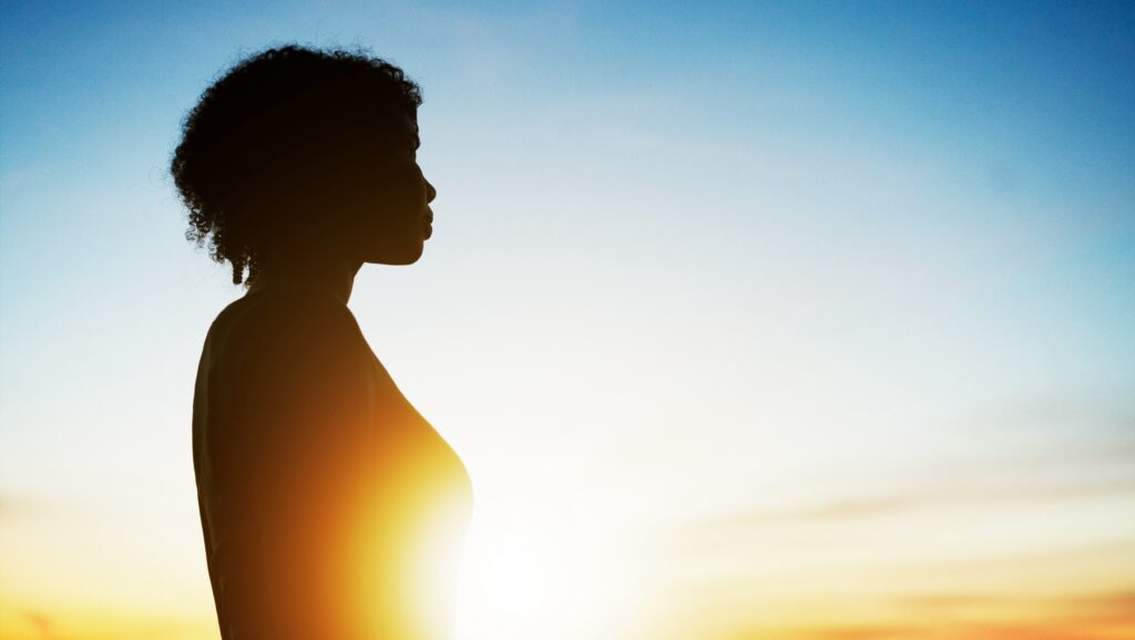 Woman looking ahead at sunset