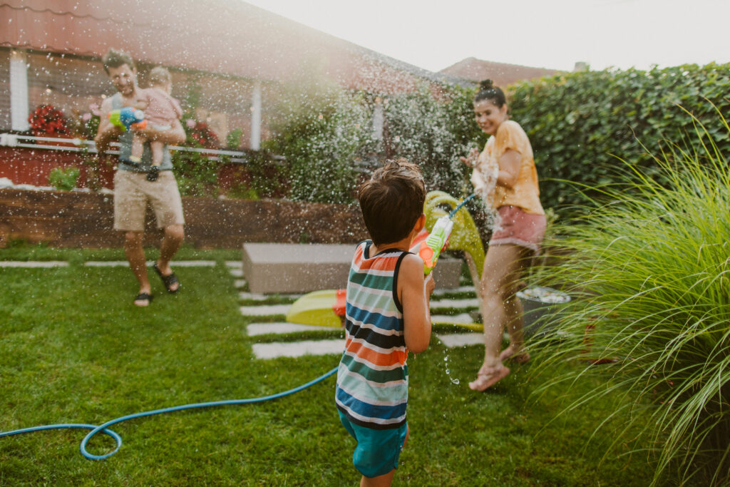 Photo of family summer water fight in the yard