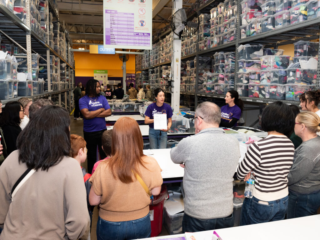 Cradles to Crayons  Volunteers in outfits station